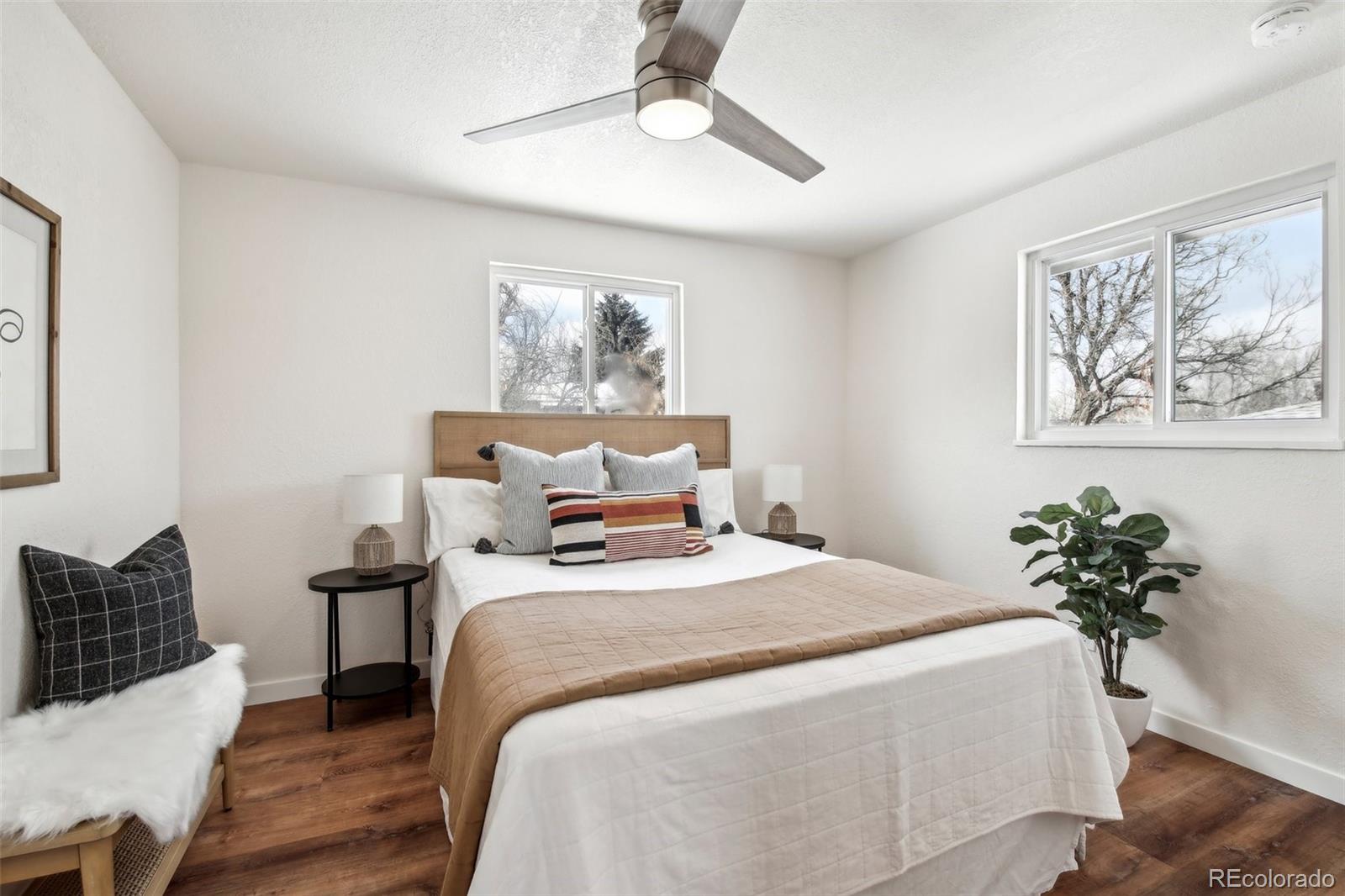 5153 Tucson Way Denver, CO 80239 - Photo 17 of 29 a bedroom with bed painting and wall painting