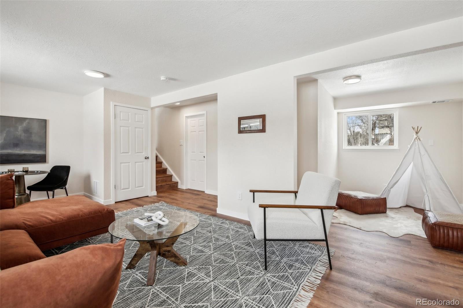5153 Tucson Way Denver, CO 80239 - Photo 20 of 29 a living room with furniture and a wooden floor