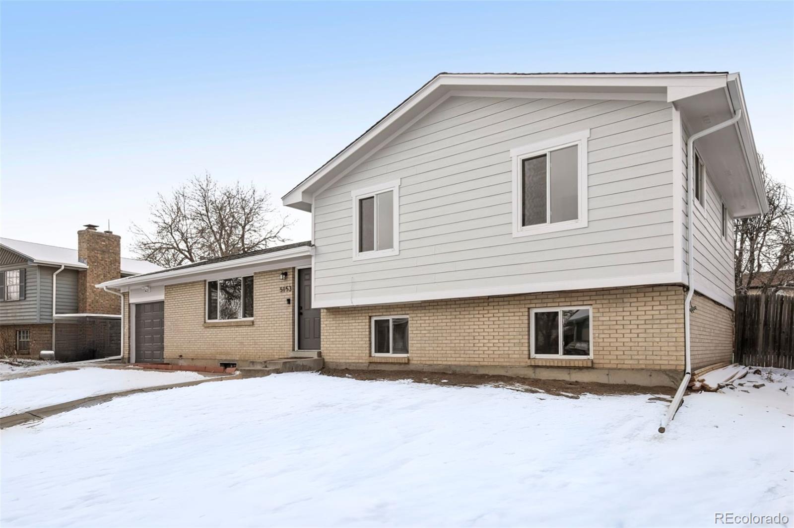 5153 Tucson Way Denver, CO 80239 - Photo 2 of 29 a front view of a house with a yard