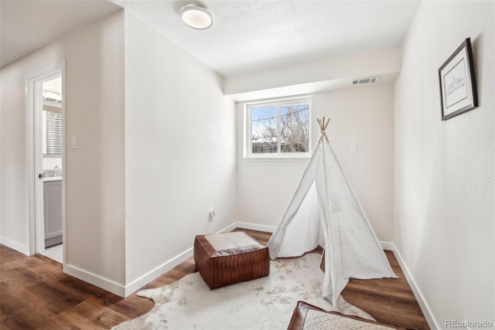 5153 Tucson Way Denver, CO 80239 - Photo 21 of 29 a view of entryway with stairs and wooden floor