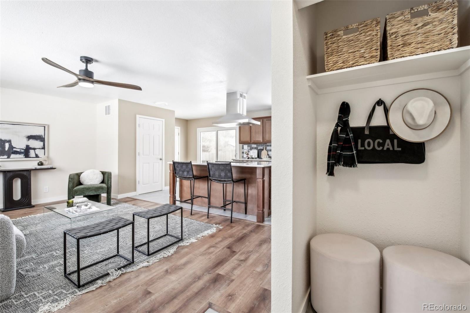 5153 Tucson Way Denver, CO 80239 - Photo 4 of 29 a living room with furniture and a wooden floor