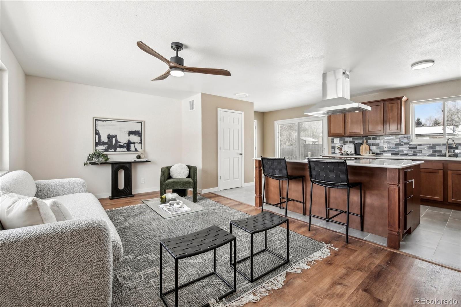 5153 Tucson Way Denver, CO 80239 - Photo 6 of 29 a living room with furniture and a wooden floor