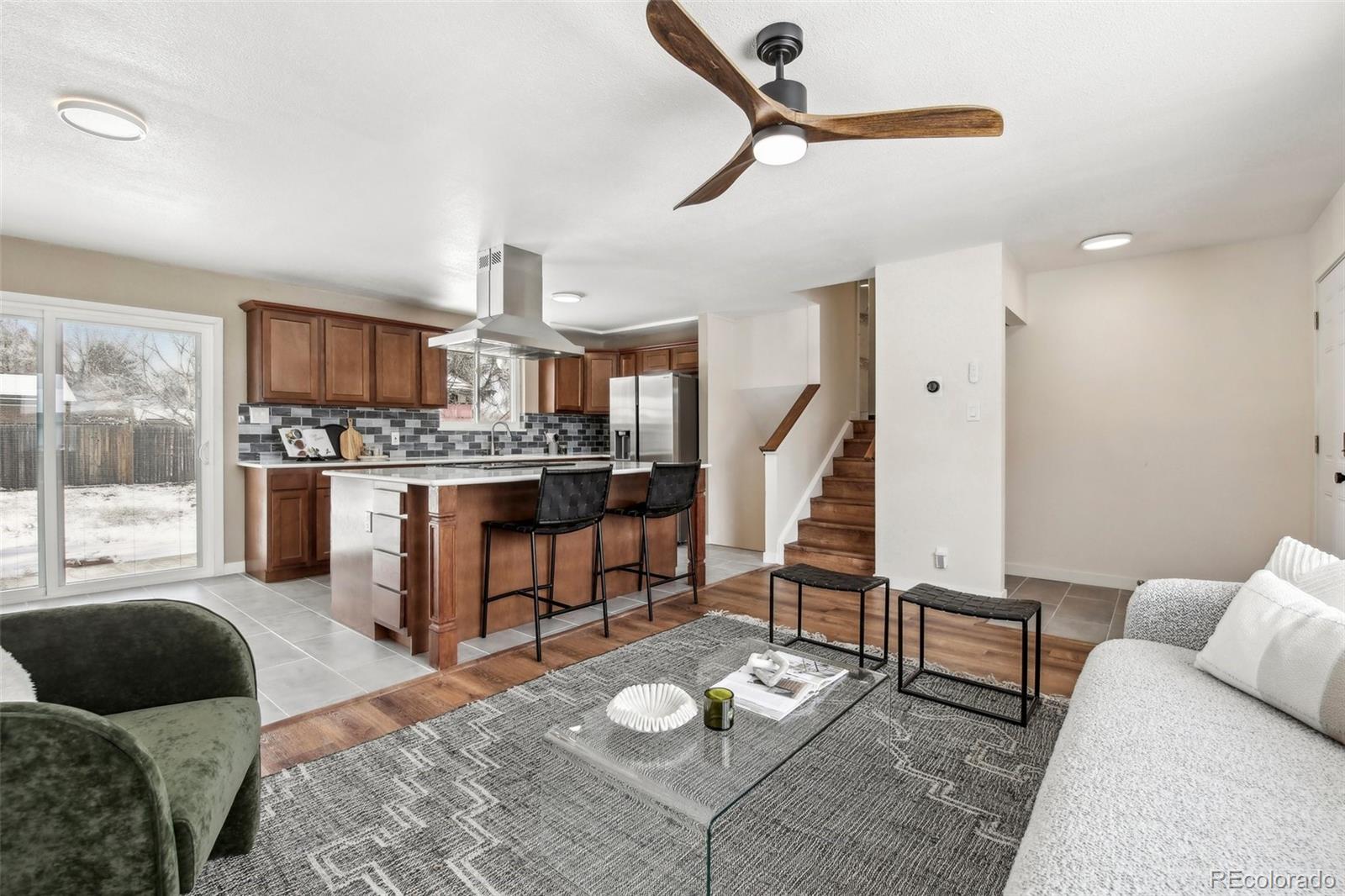 5153 Tucson Way Denver, CO 80239 - Photo 7 of 29 a living room with furniture and a wooden floor