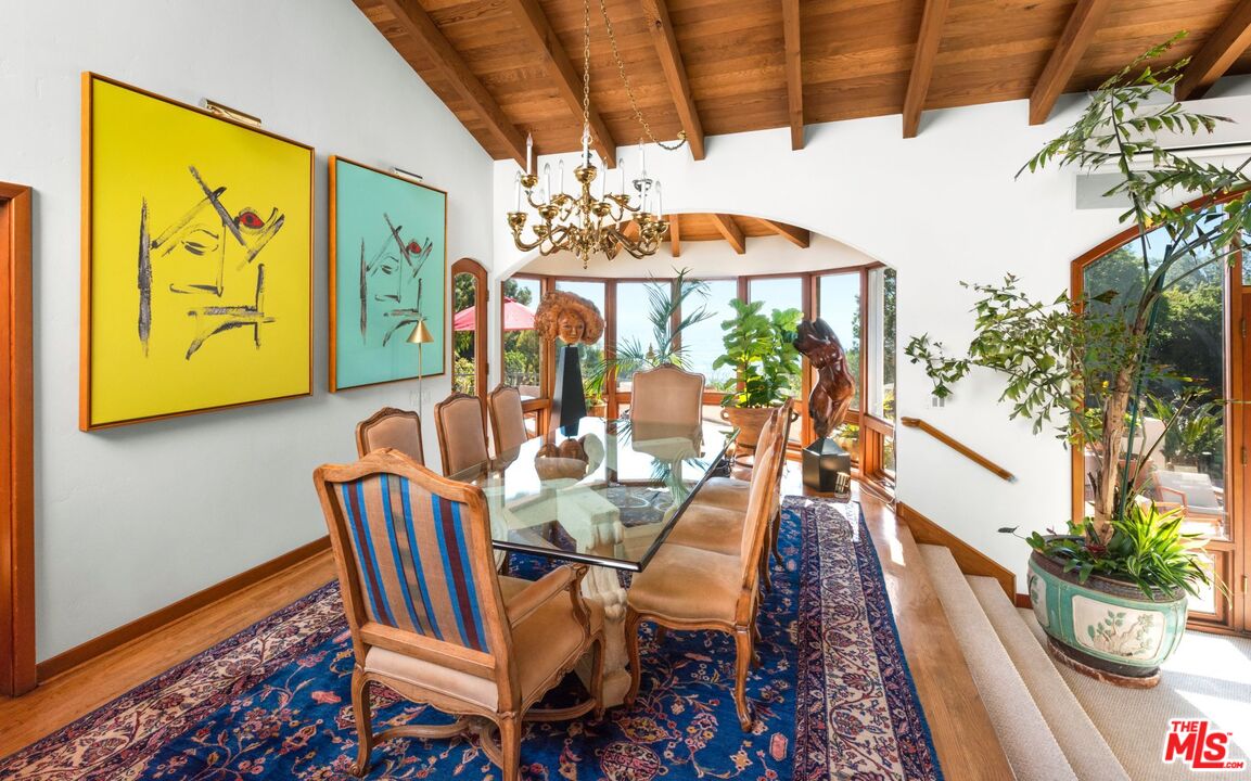 27910 Pacific Coast Highway Malibu, CA 90265 - Photo 20 of 28 a view of a dining room with furniture a chandelier and wooden floor