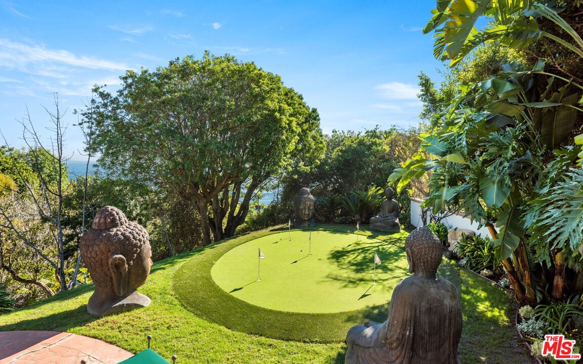 27910 Pacific Coast Highway Malibu, CA 90265 - Photo 27 of 28 a view of a swimming pool with a garden