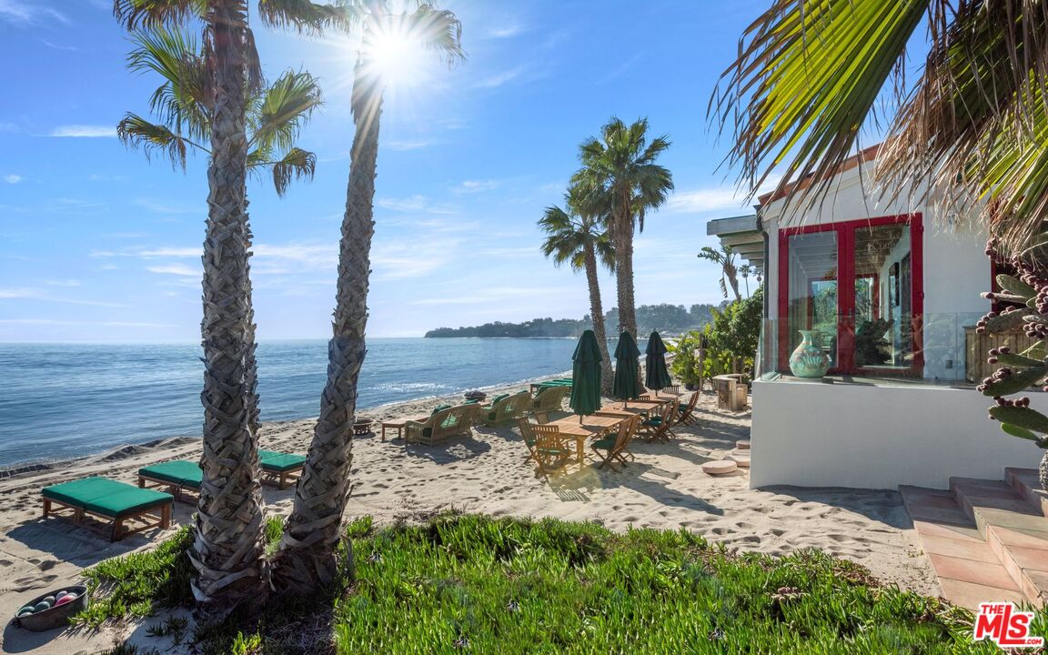 27910 Pacific Coast Highway Malibu, CA 90265 - Photo 3 of 28 a view of a backyard with a patio and swimming pool