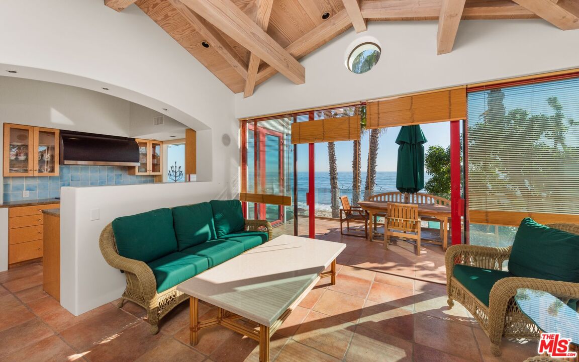 27910 Pacific Coast Highway Malibu, CA 90265 - Photo 8 of 28 a living room with furniture a rug and a floor to ceiling window