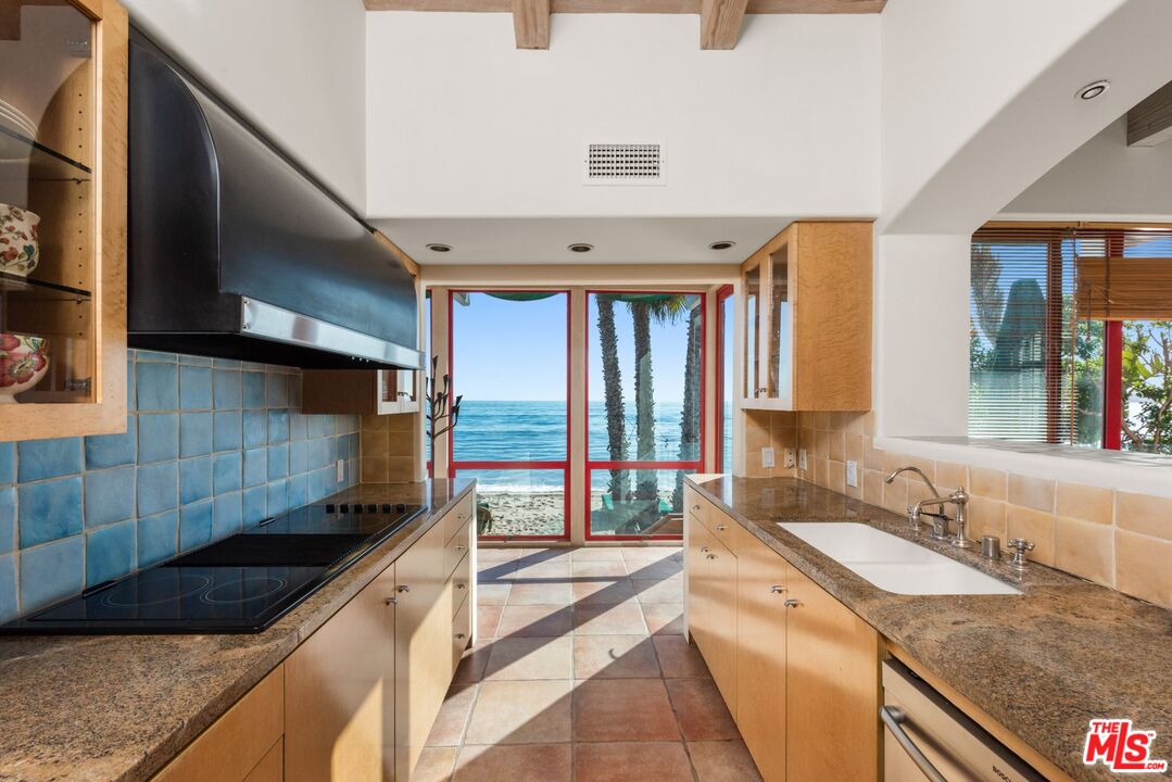 27910 Pacific Coast Highway Malibu, CA 90265 - Photo 9 of 28 a kitchen with stainless steel appliances granite countertop a sink and a stove