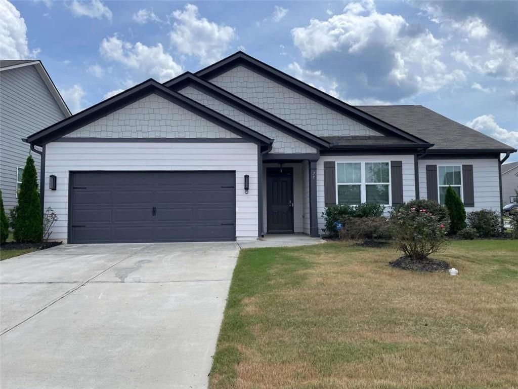 a front view of house with yard and trees around