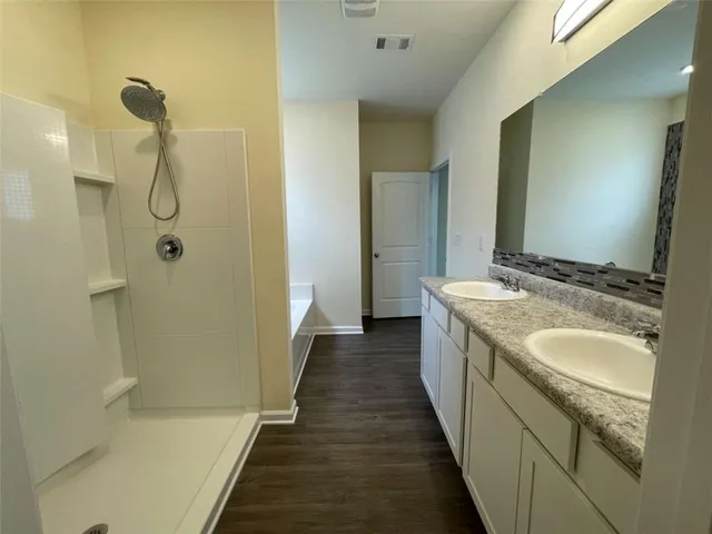 a spacious bathroom with a shower and a sink