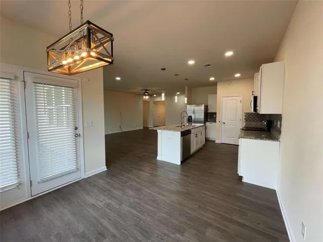 a view of kitchen with cabinets and wooden floor