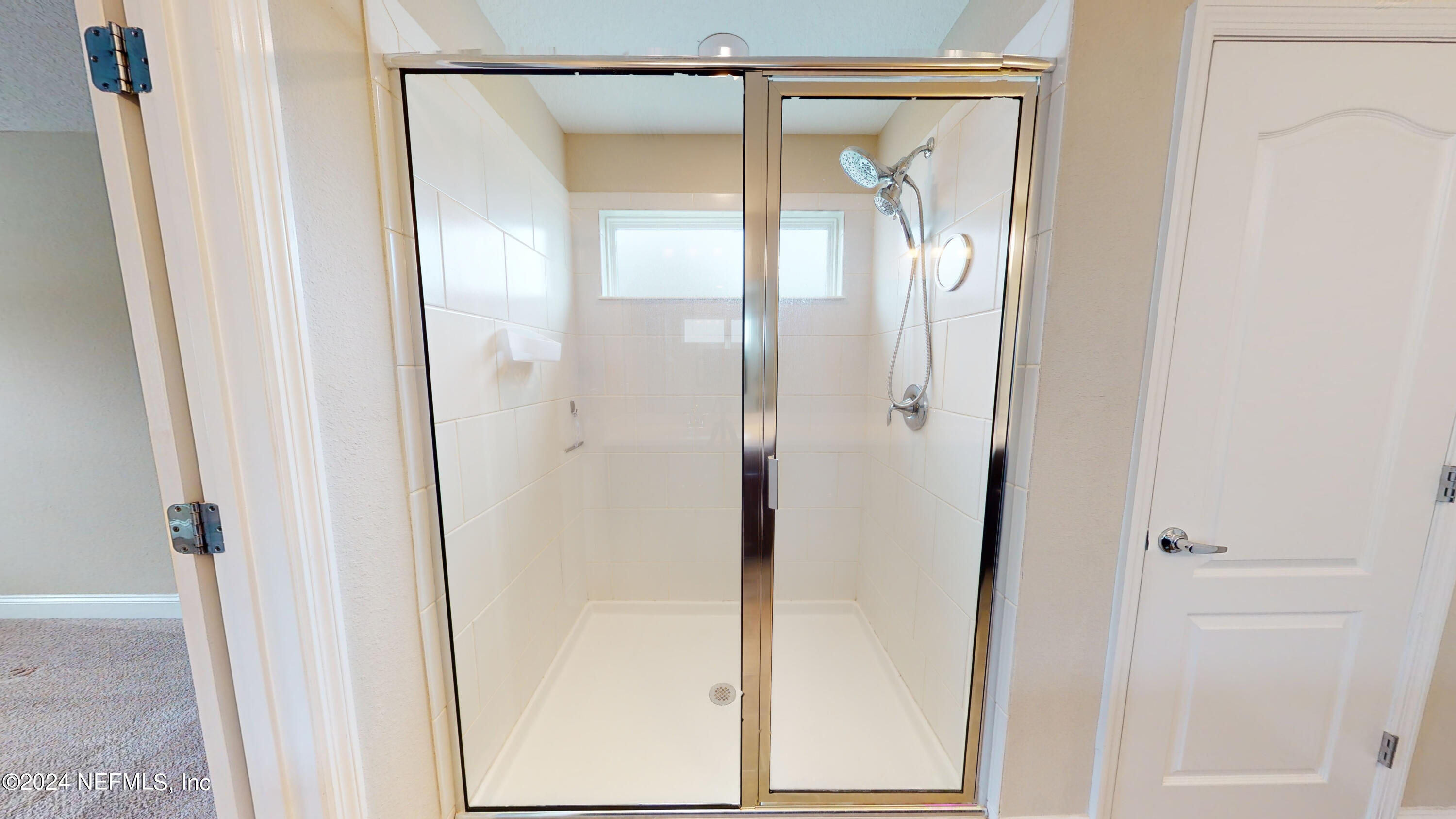 201 Silver Creek Place St. Augustine, FL 32095 - Photo 20 of 25 a bathroom with a glass shower door and a mirror