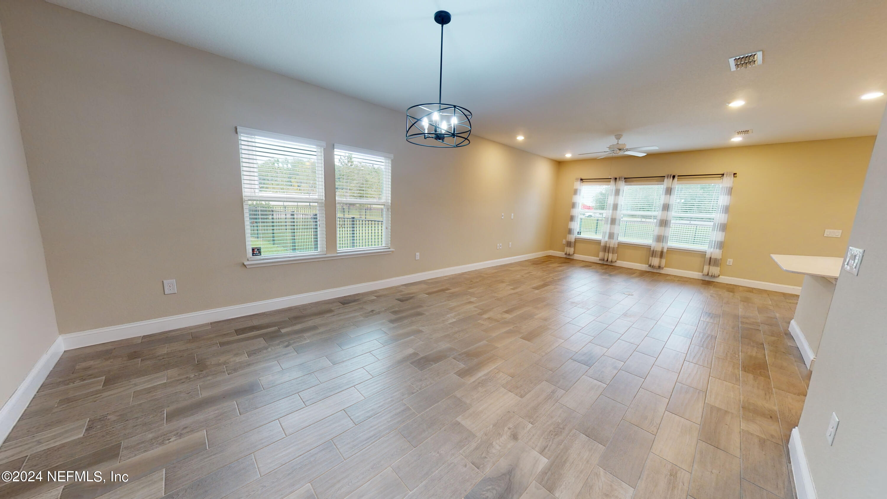 201 Silver Creek Place St. Augustine, FL 32095 - Photo 5 of 25 a view of an empty room with wooden floor and a window