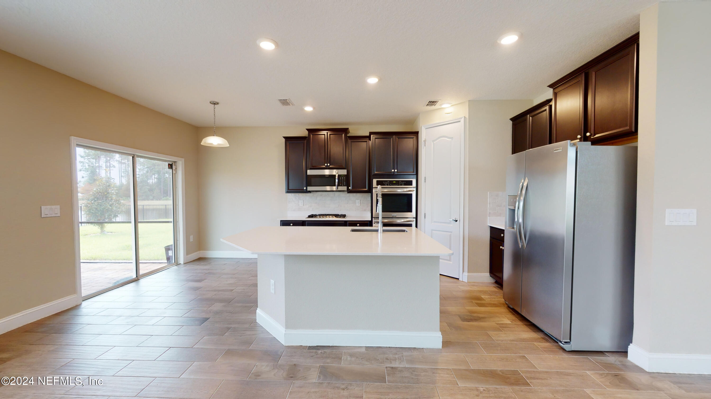 201 Silver Creek Place St. Augustine, FL 32095 - Photo 7 of 25 a kitchen with stainless steel appliances a refrigerator and a stove top oven