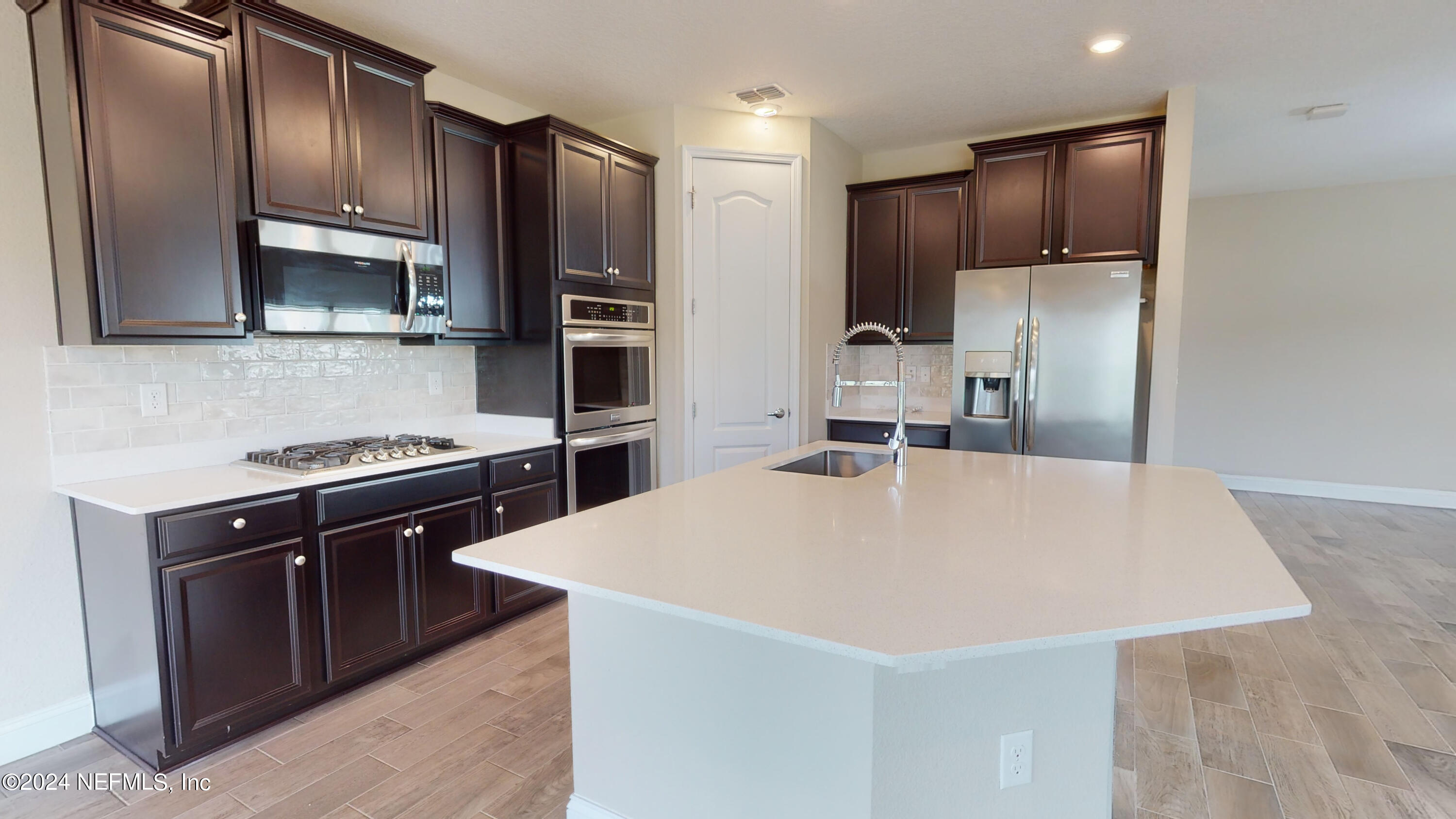 201 Silver Creek Place St. Augustine, FL 32095 - Photo 10 of 25 a kitchen with stainless steel appliances a refrigerator and a stove top oven