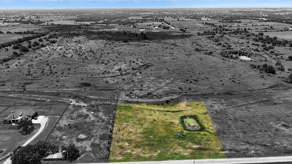 an aerial view of house with yard