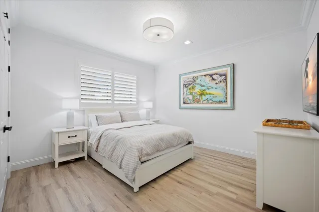 a view of bedroom with natural light and wooden floor