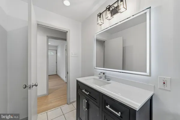 a bathroom with a sink vanity and a mirror