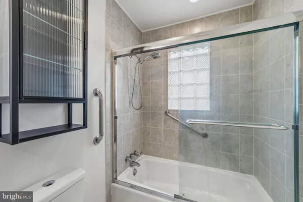 a bathroom with a shower and a bathtub
