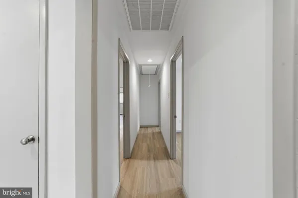 a view of a hallway with a white walls