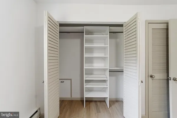 a view of walk in closet with empty racks