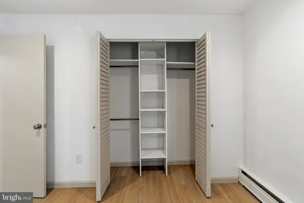 a view of walk in closet with empty racks