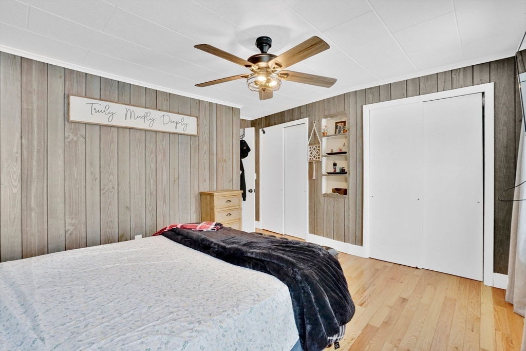 24 Clinton Street Ware, MA 01082 - Photo 24 of 41 a bedroom with a large bed and a chandelier