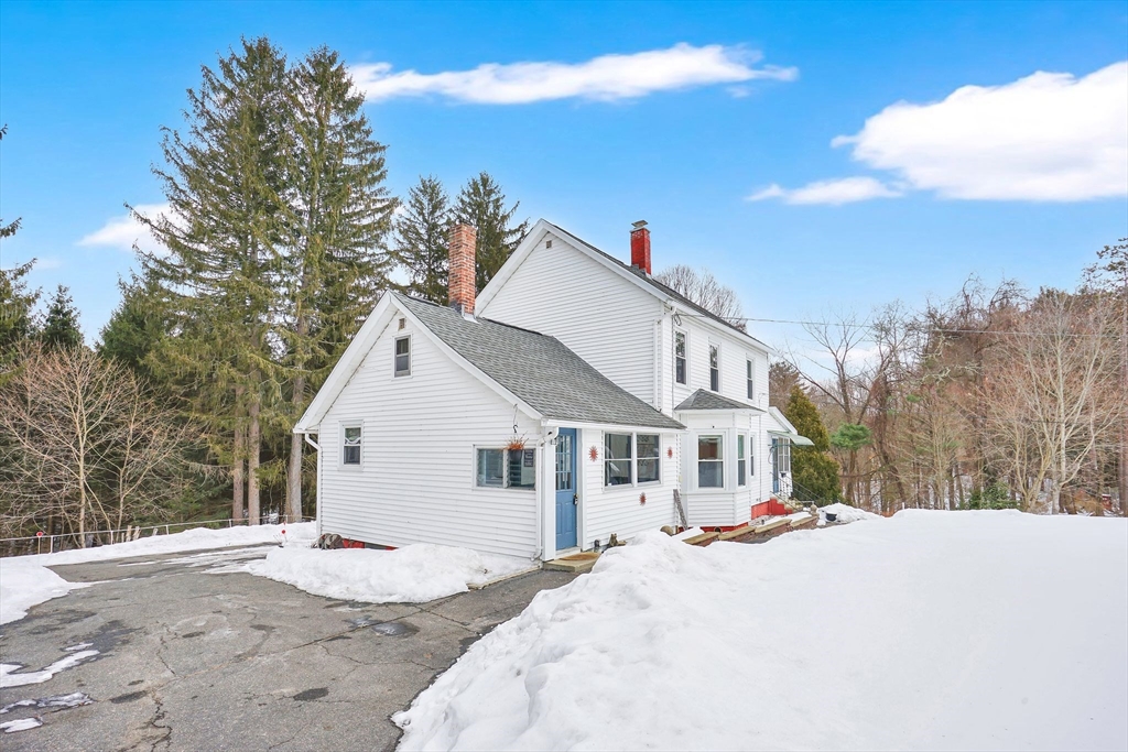 24 Clinton Street Ware, MA 01082 - Photo 3 of 41 a view of a white house with a yard covered in snow