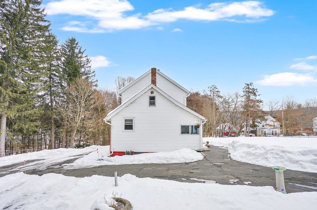 24 Clinton Street Ware, MA 01082 - Photo 4 of 41 a view of a white house with a snow on the road