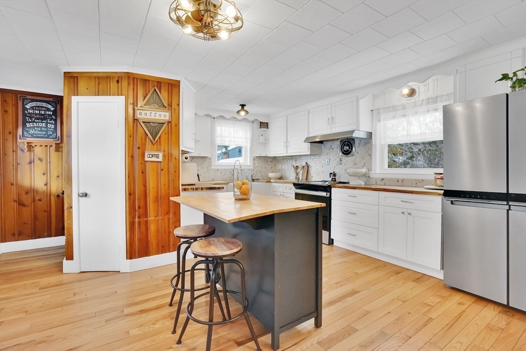 24 Clinton Street Ware, MA 01082 - Photo 8 of 41 a kitchen with stainless steel appliances a refrigerator a sink a stove a dining table and chairs