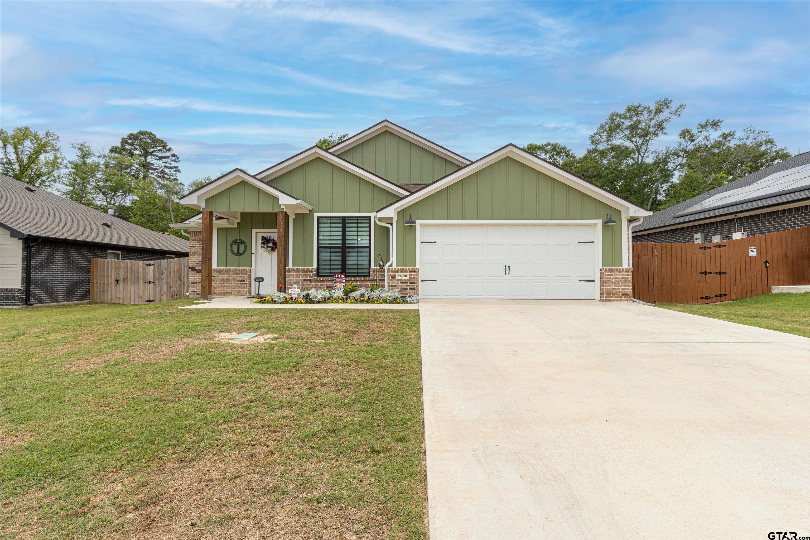 16210 Crossing Circle Lindale, TX 75771 - Photo 1 of 22 a front view of a house with a yard garage and outdoor seating