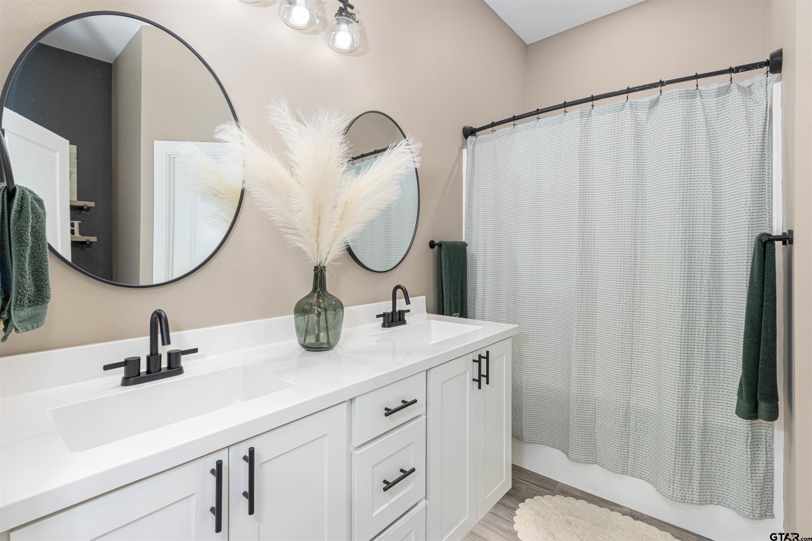 16210 Crossing Circle Lindale, TX 75771 - Photo 12 of 22 a bathroom with a double vanity sink and a mirror