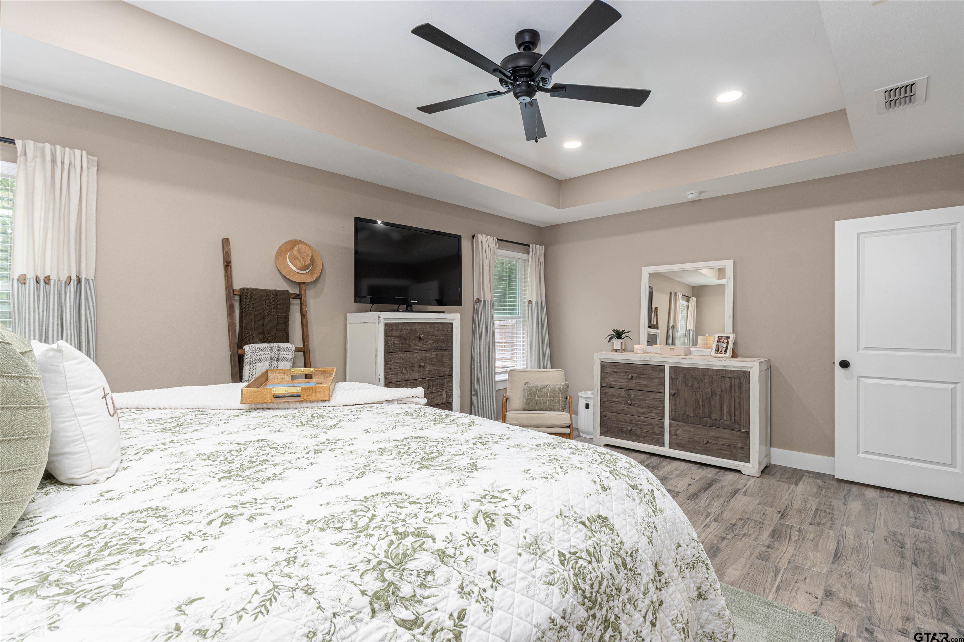 16210 Crossing Circle Lindale, TX 75771 - Photo 13 of 22 a bedroom with a large bed and a flat screen tv