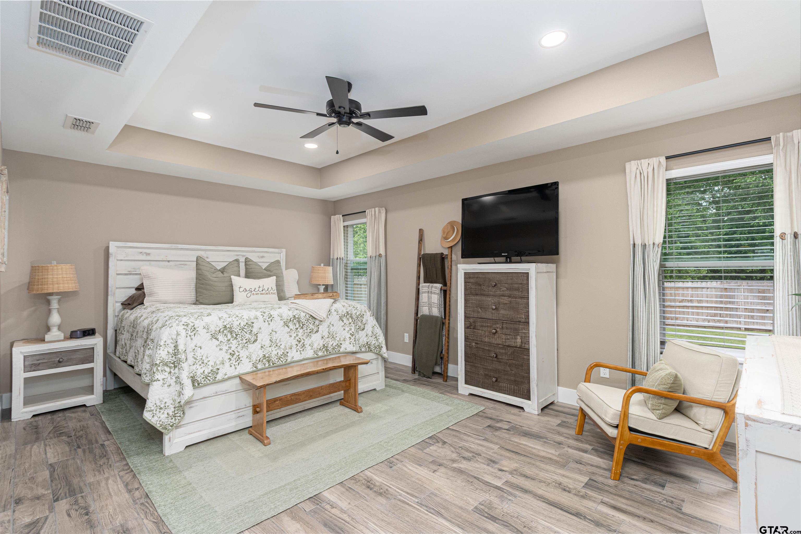 16210 Crossing Circle Lindale, TX 75771 - Photo 14 of 22 a bedroom with a bed and a flat screen tv