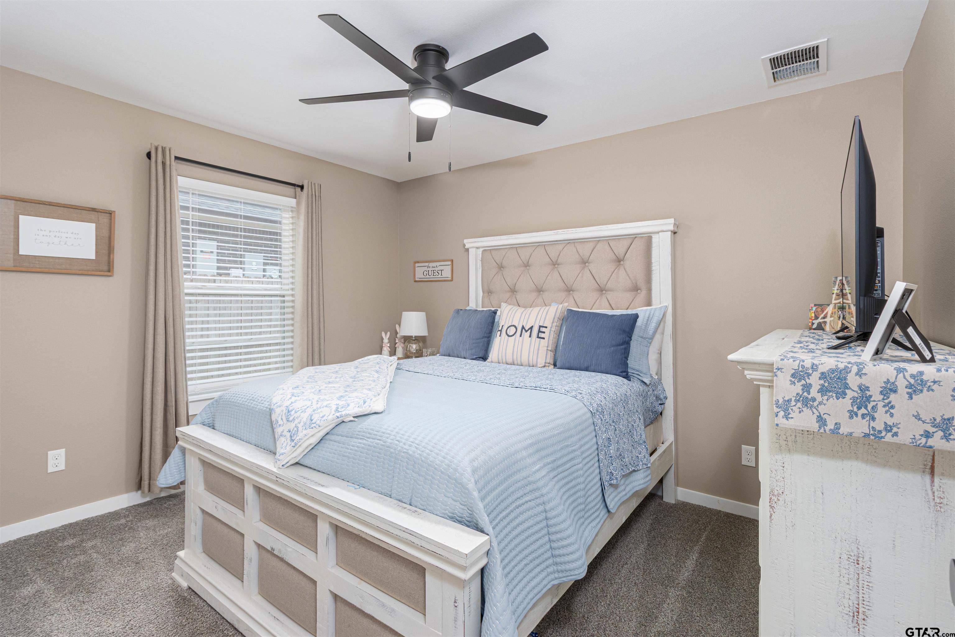 16210 Crossing Circle Lindale, TX 75771 - Photo 15 of 22 a bedroom with a bed and a chandelier