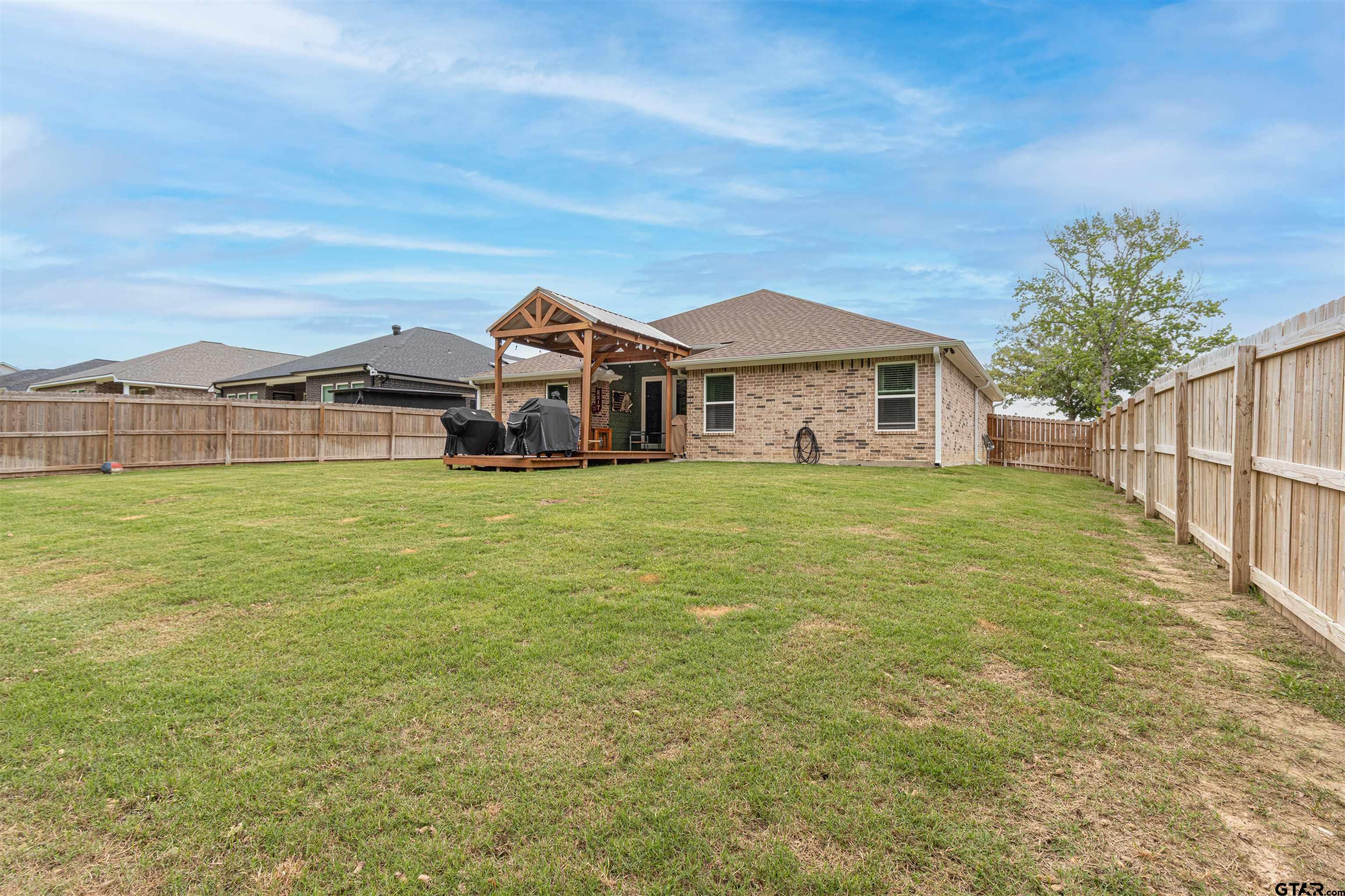 16210 Crossing Circle Lindale, TX 75771 - Photo 21 of 22 a view of a house with a big yard and large trees
