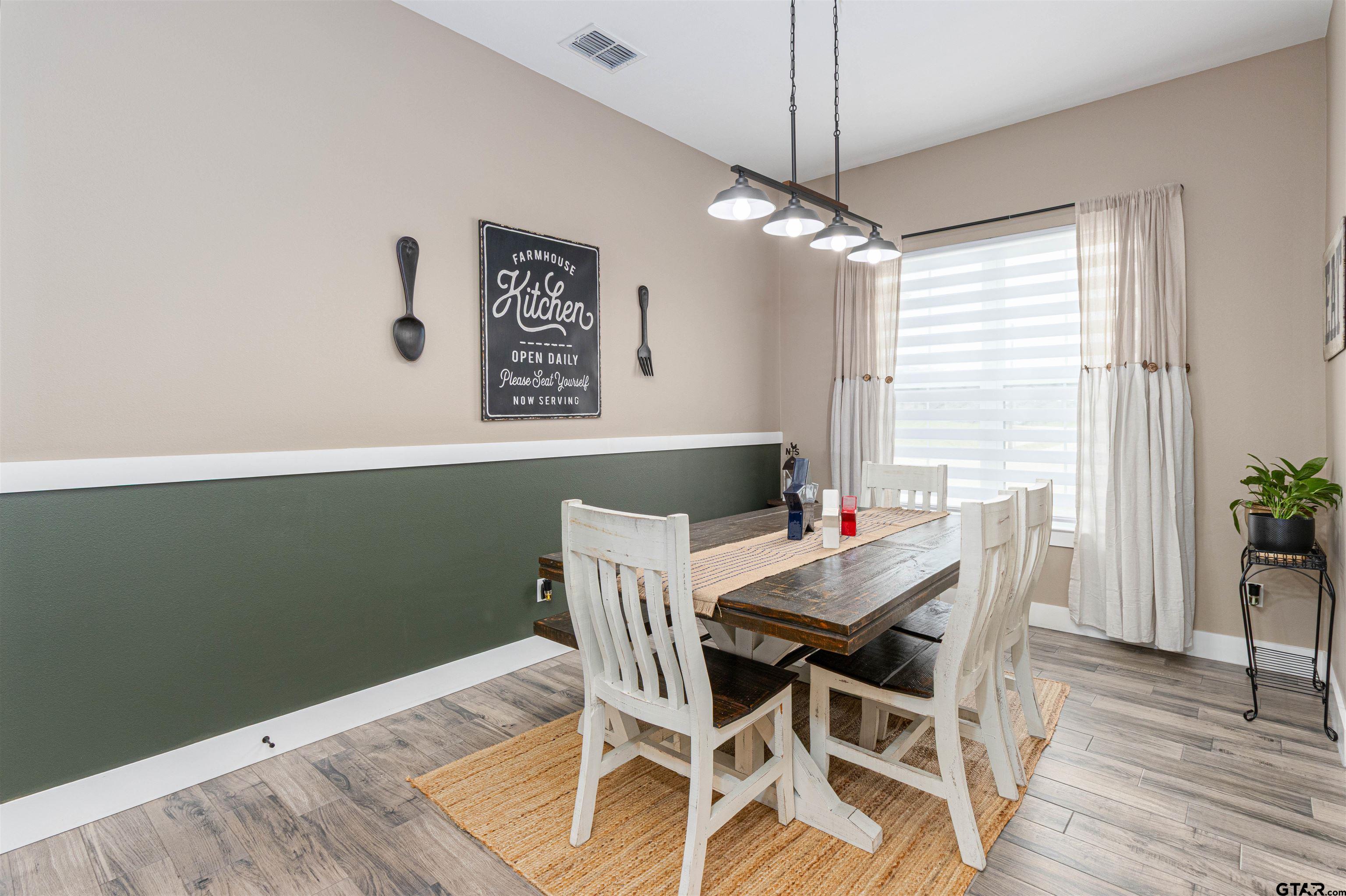 16210 Crossing Circle Lindale, TX 75771 - Photo 7 of 22 a view of a dining room with furniture window and wooden floor