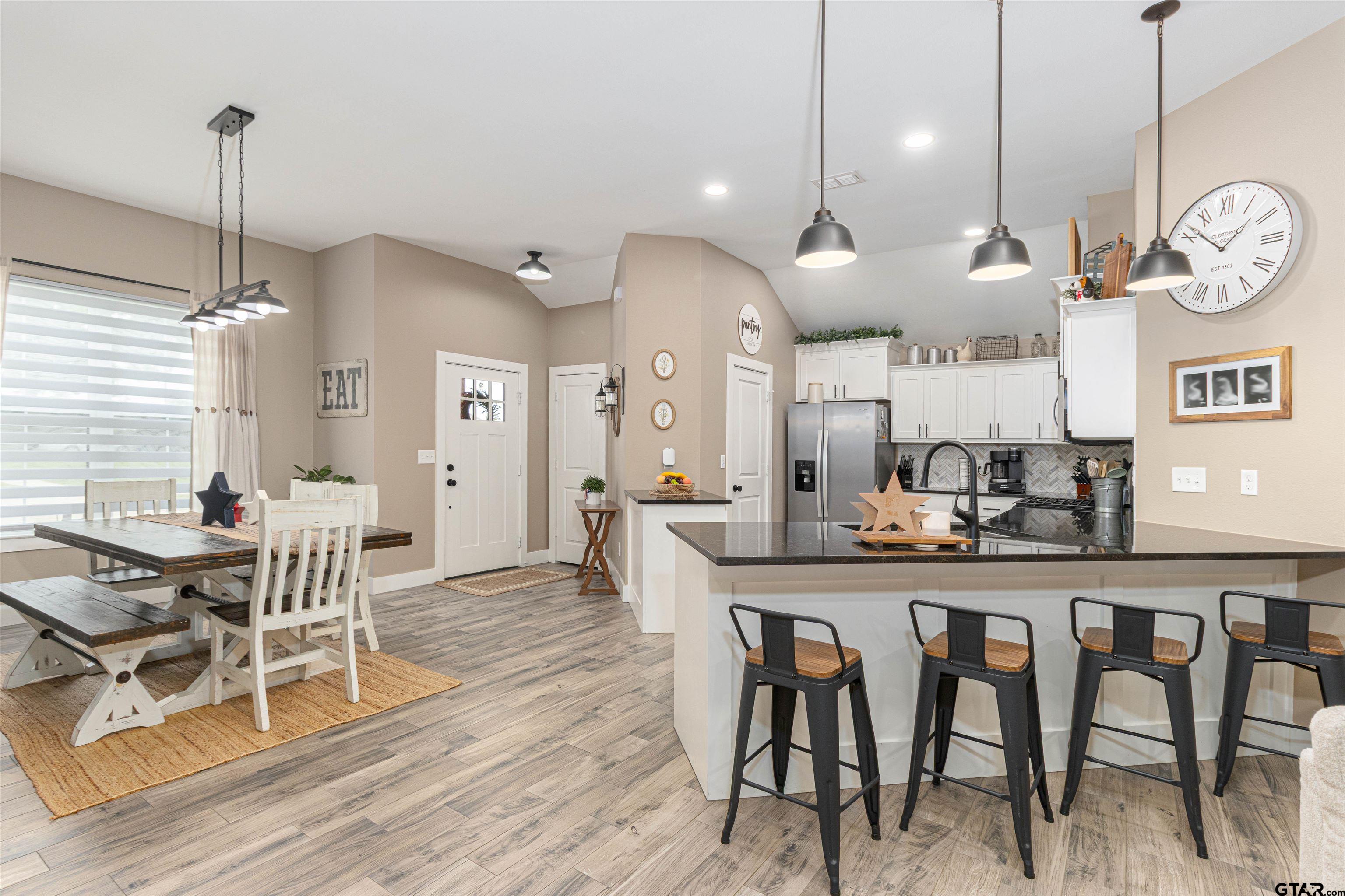 16210 Crossing Circle Lindale, TX 75771 - Photo 8 of 22 an open kitchen with a table and chairs
