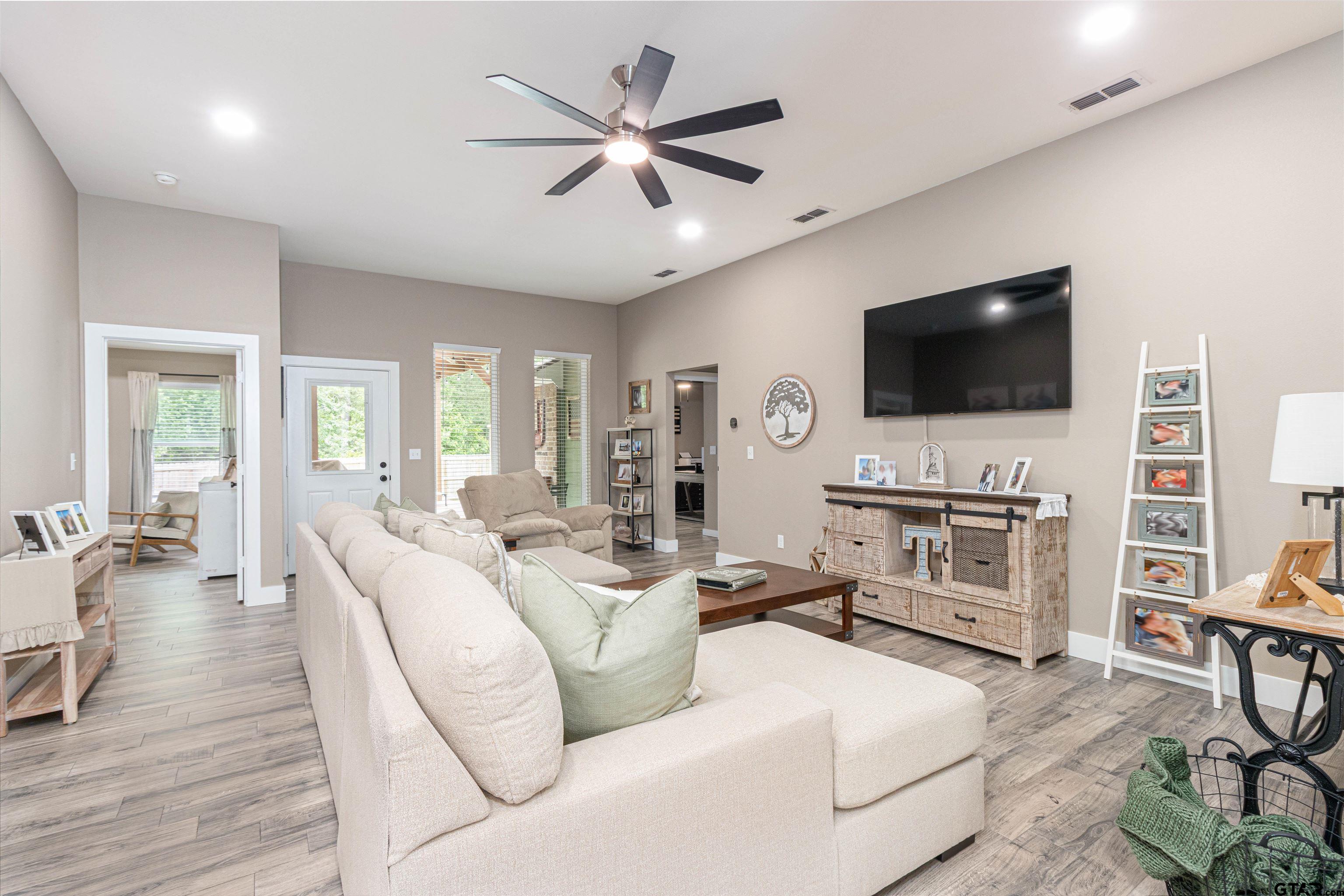 16210 Crossing Circle Lindale, TX 75771 - Photo 9 of 22 a living room with furniture and a flat screen tv