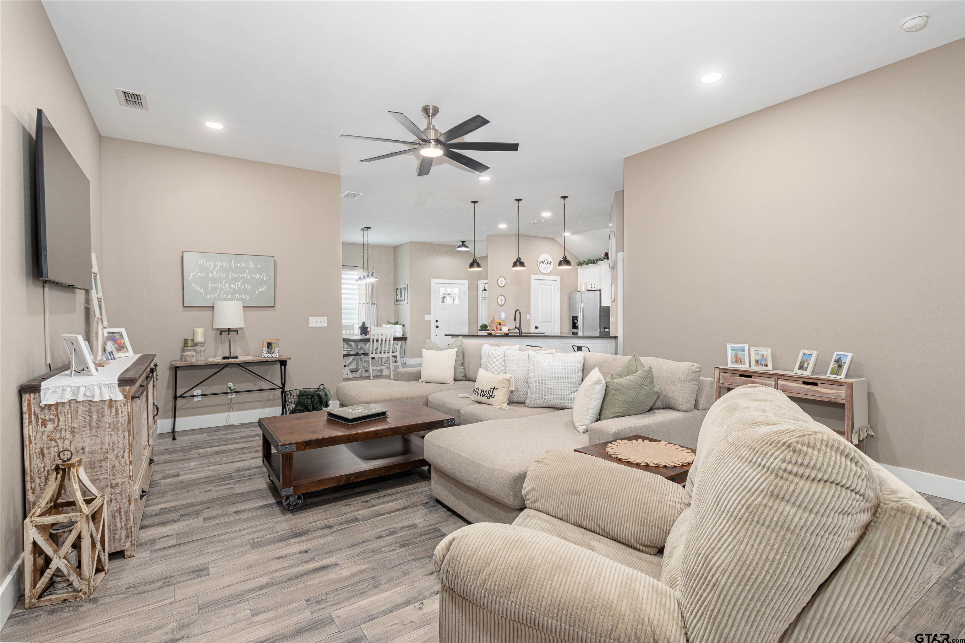16210 Crossing Circle Lindale, TX 75771 - Photo 10 of 22 a living room with furniture white walls and a flat screen tv