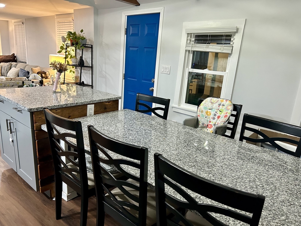 9 Church Street, Unit 9 Woburn, MA 01801 - Photo 12 of 31 a kitchen with a table and chairs in it