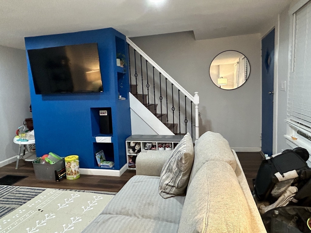 9 Church Street, Unit 9 Woburn, MA 01801 - Photo 15 of 31 a living room with furniture and a flat screen tv