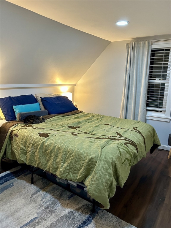 9 Church Street, Unit 9 Woburn, MA 01801 - Photo 18 of 31 a bed sitting in a bedroom next to a window