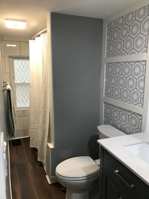 9 Church Street, Unit 9 Woburn, MA 01801 - Photo 24 of 31 a bathroom with a granite countertop sink toilet and a shower