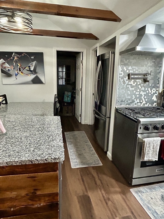 9 Church Street, Unit 9 Woburn, MA 01801 - Photo 7 of 31 a kitchen with granite countertop a refrigerator and wooden floor