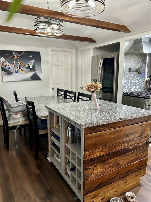 9 Church Street, Unit 9 Woburn, MA 01801 - Photo 9 of 31 a kitchen with stainless steel appliances granite countertop a stove and a dining table