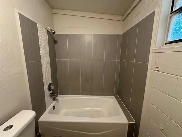 a bathroom with a tub and a shower