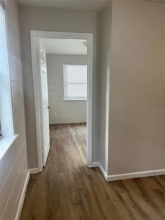 a view of a hallway with wooden floor