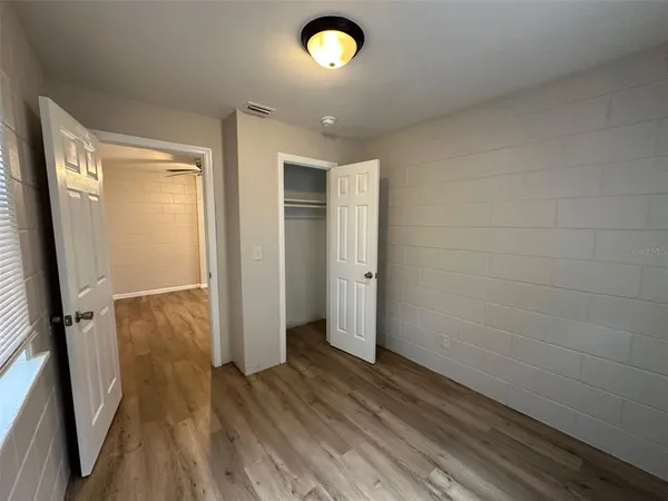 a view of a livingroom with wooden floor and a window