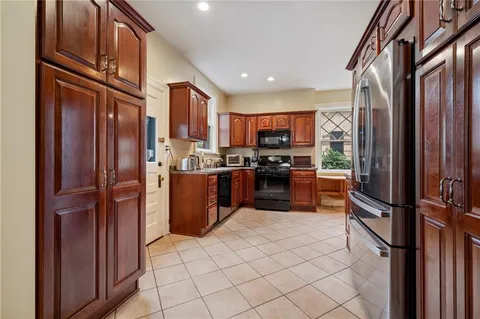 a kitchen with stainless steel appliances granite countertop a refrigerator and a stove top oven
